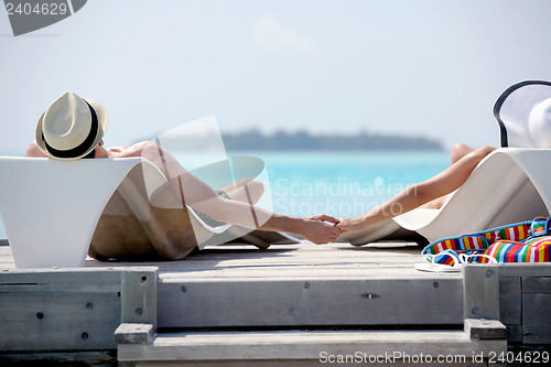 Image of happy young couple have fun on beach