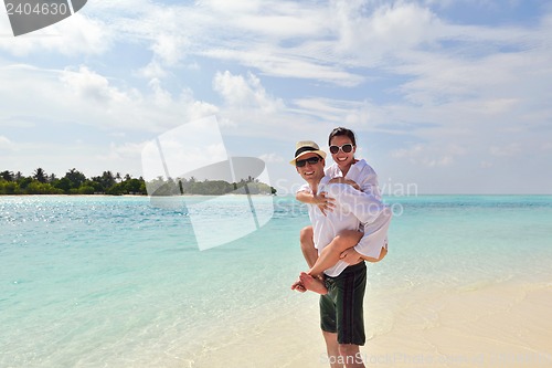 Image of happy young couple have fun on beach