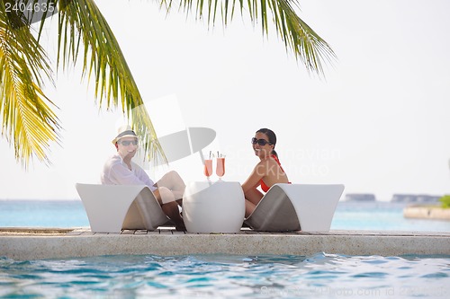 Image of happy young couple relax and take fresh drink