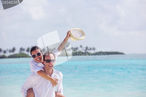 Image of happy young couple have fun on beach