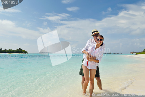 Image of happy young couple have fun on beach