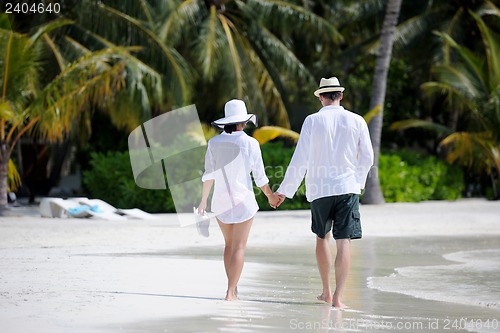 Image of happy young couple have fun on beach