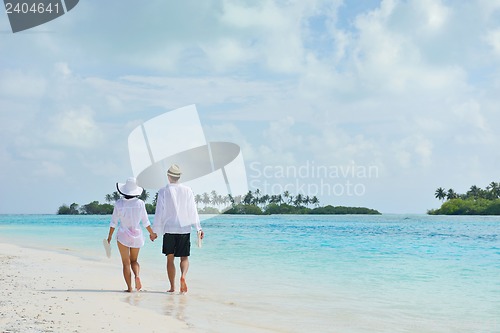 Image of happy young couple have fun on beach