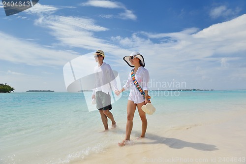 Image of happy young couple have fun on beach