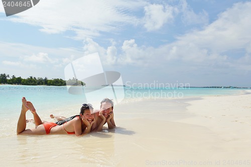 Image of happy young couple have fun on beach
