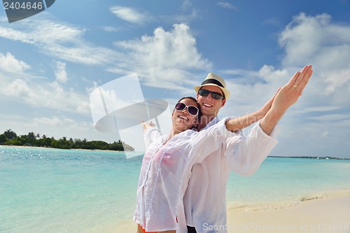 Image of happy young couple have fun on beach