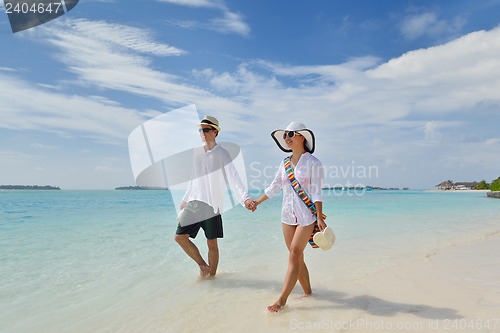 Image of happy young couple have fun on beach