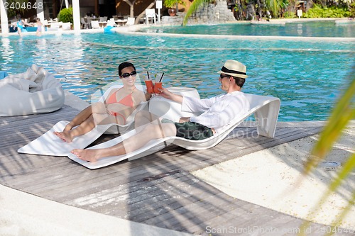 Image of happy young couple relax and take fresh drink
