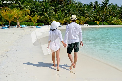 Image of happy young couple have fun on beach