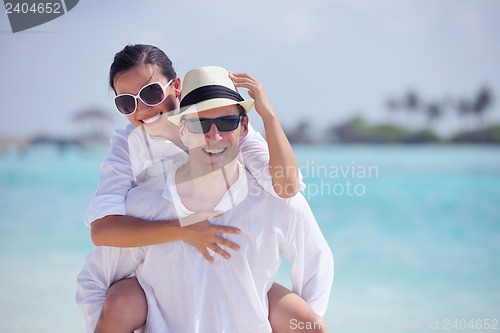 Image of happy young couple have fun on beach