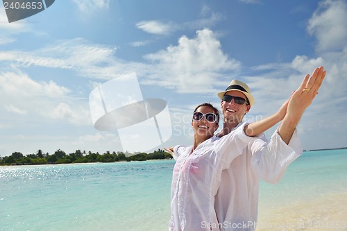 Image of happy young couple have fun on beach
