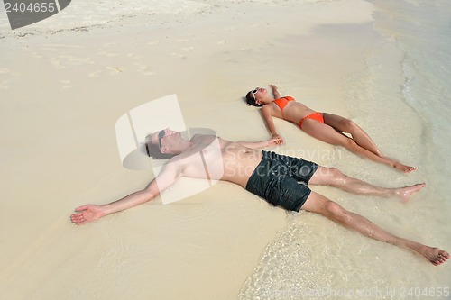 Image of happy young couple have fun on beach