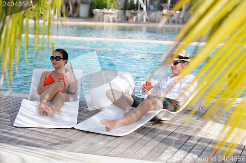 Image of happy young couple relax and take fresh drink