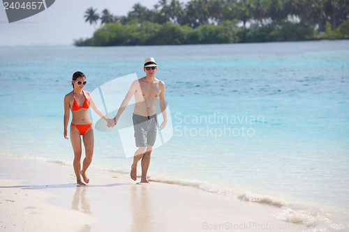 Image of happy young couple have fun on beach