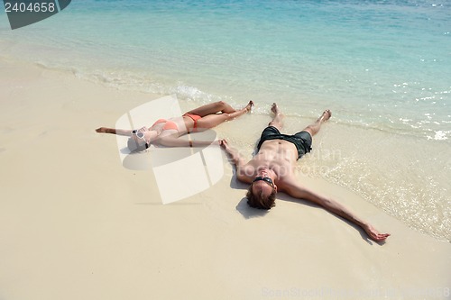 Image of happy young couple have fun on beach