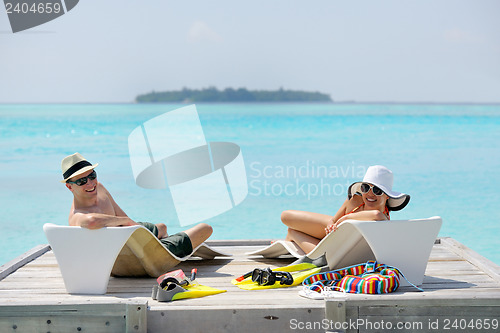 Image of happy young couple have fun on beach