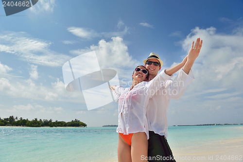 Image of happy young couple have fun on beach