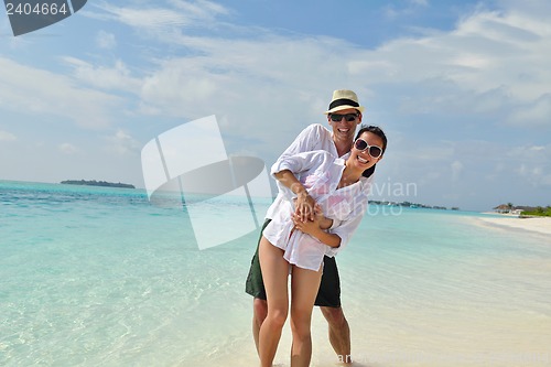 Image of happy young couple have fun on beach