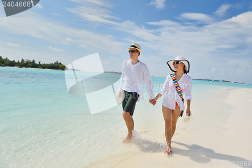 Image of happy young couple have fun on beach