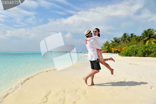 Image of happy young couple have fun on beach
