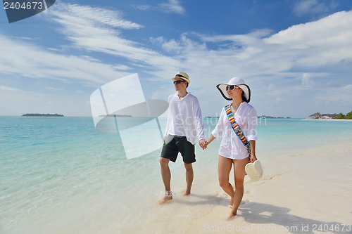 Image of happy young couple have fun on beach