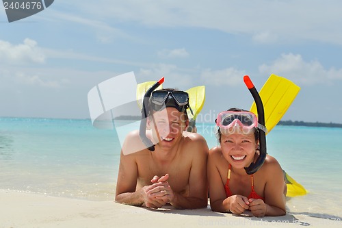Image of happy young couple have fun on beach
