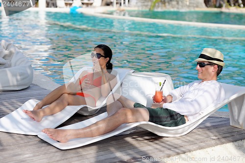 Image of happy young couple relax and take fresh drink