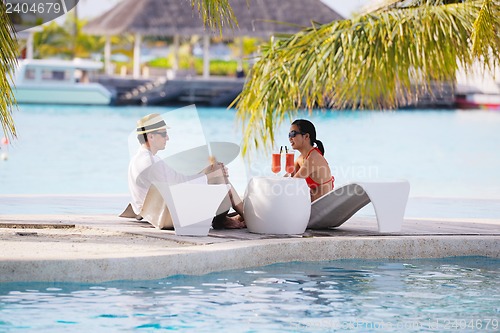 Image of happy young couple relax and take fresh drink