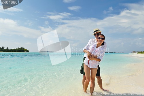 Image of happy young couple have fun on beach