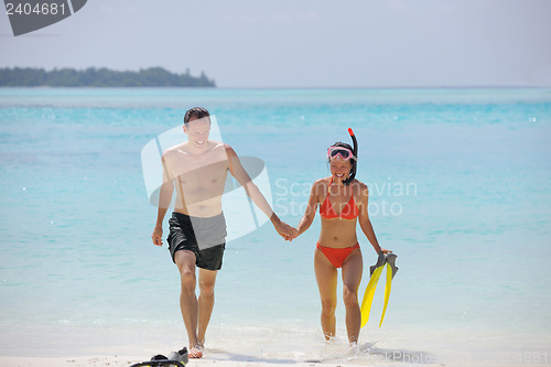 Image of happy young couple have fun on beach