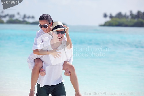 Image of happy young couple have fun on beach