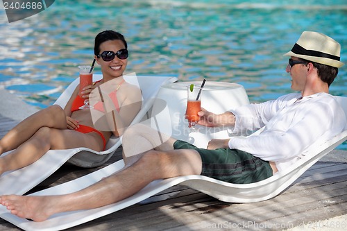 Image of happy young couple relax and take fresh drink