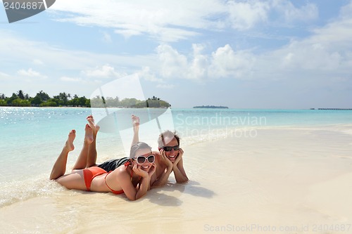Image of happy young couple have fun on beach