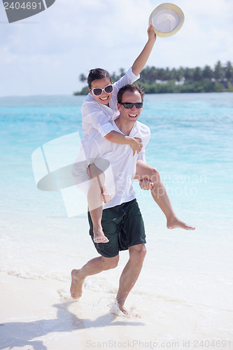 Image of happy young couple have fun on beach