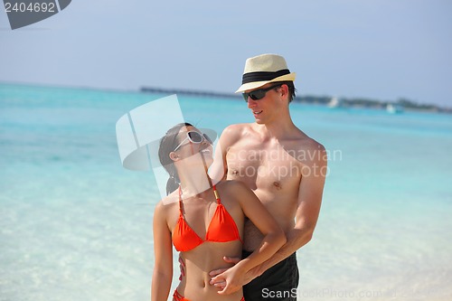 Image of happy young couple have fun on beach