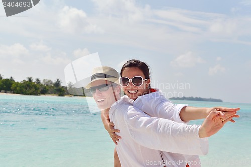 Image of happy young couple have fun on beach