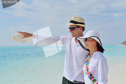 Image of happy young couple have fun on beach
