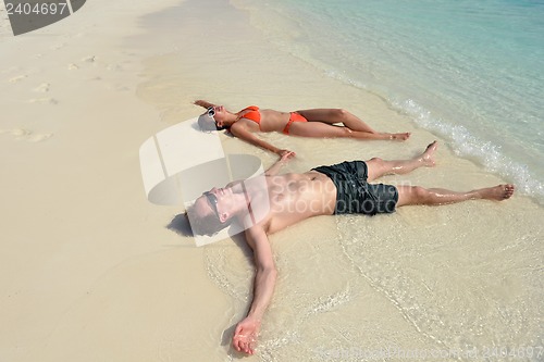 Image of happy young couple have fun on beach