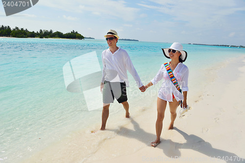 Image of happy young couple have fun on beach