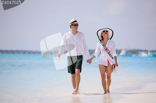 Image of happy young couple have fun on beach