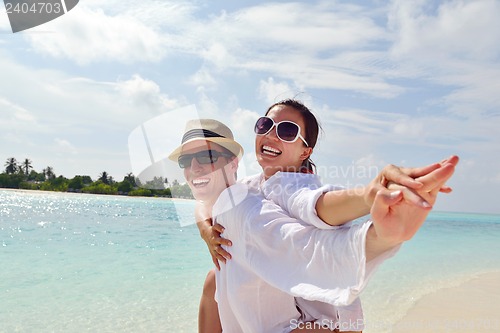 Image of happy young couple have fun on beach