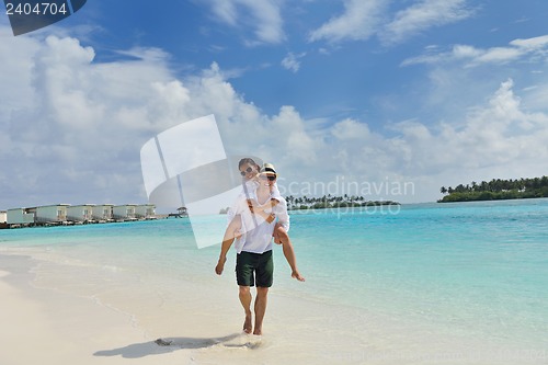 Image of happy young couple have fun on beach