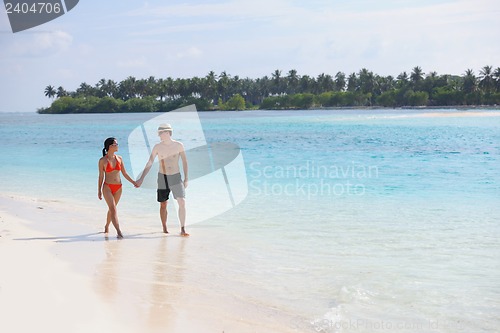 Image of happy young couple have fun on beach