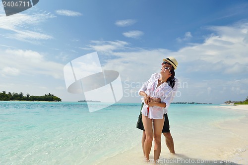 Image of happy young couple have fun on beach