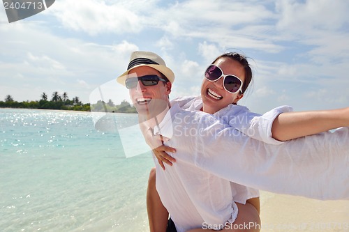 Image of happy young couple have fun on beach