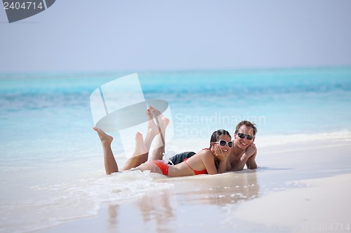 Image of happy young couple have fun on beach
