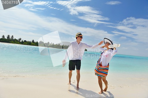 Image of happy young couple have fun on beach