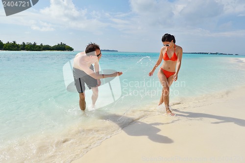 Image of happy young couple have fun on beach
