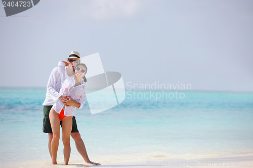 Image of happy young couple have fun on beach