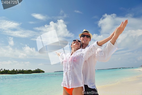 Image of happy young couple have fun on beach